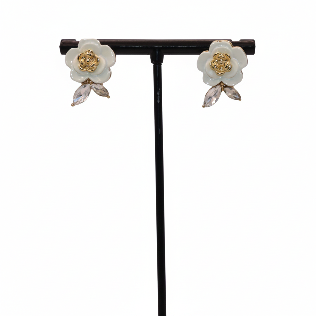 Floral earrings on a black stand against a white background