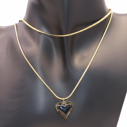 A Gold necklace featuring a heart pendant