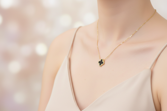 Gold necklace with a Black clover-shaped pendant