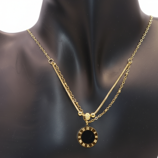 Gold necklace with a black pendant