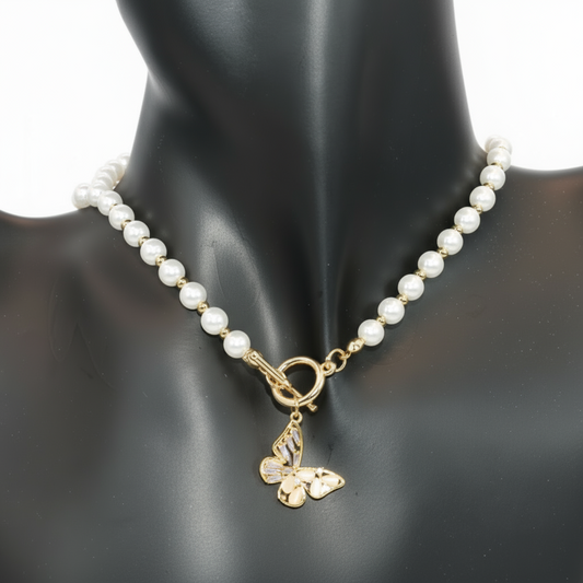 Pearl necklace with a gold butterfly charm