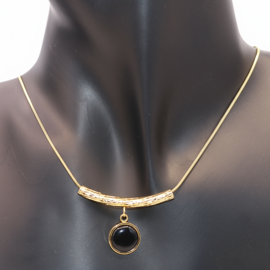 Gold necklace with a black pendant