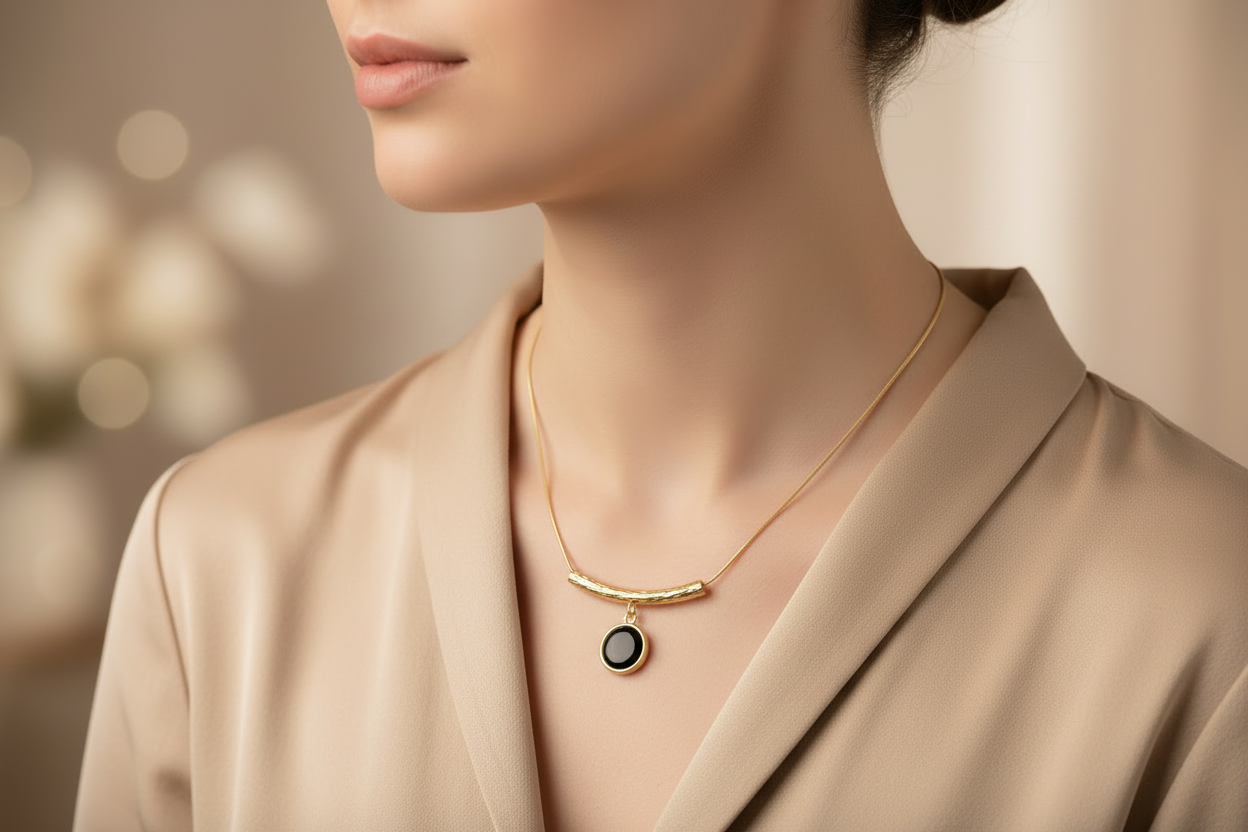 Gold necklace with a black pendant