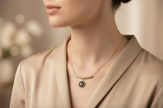 Gold necklace with a black pendant