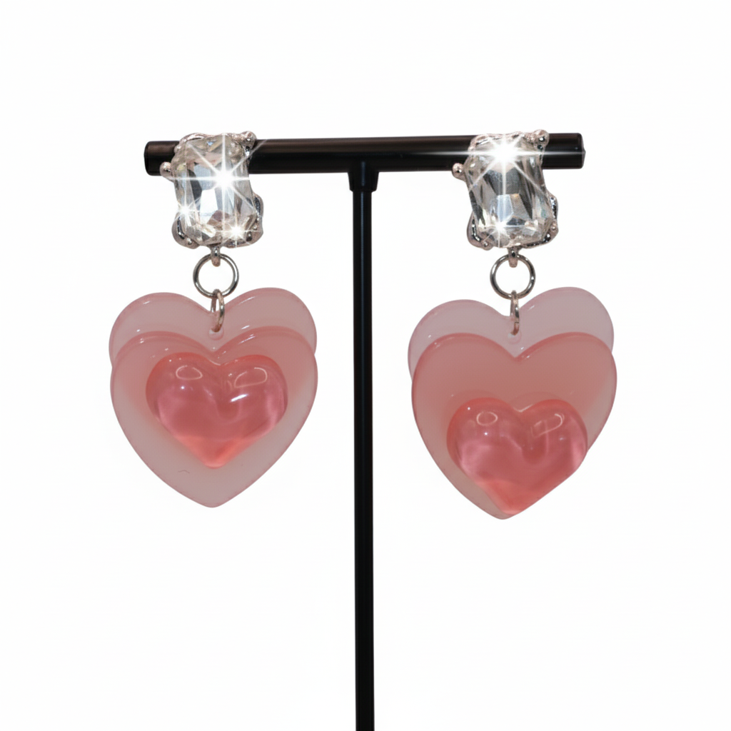 Heart-shaped earrings with pink and clear heart design 