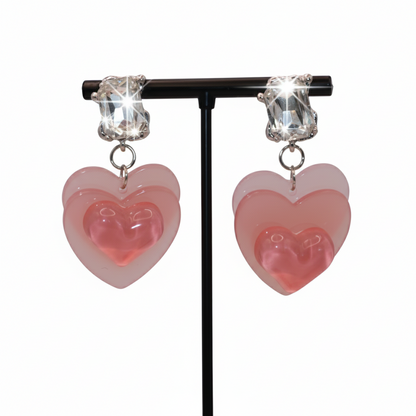 Heart-shaped earrings with pink and clear heart design 