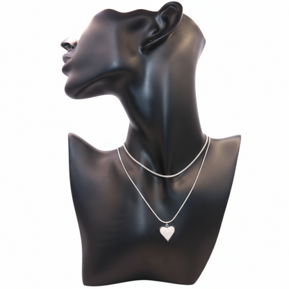 a silver necklace featuring a heart pendant