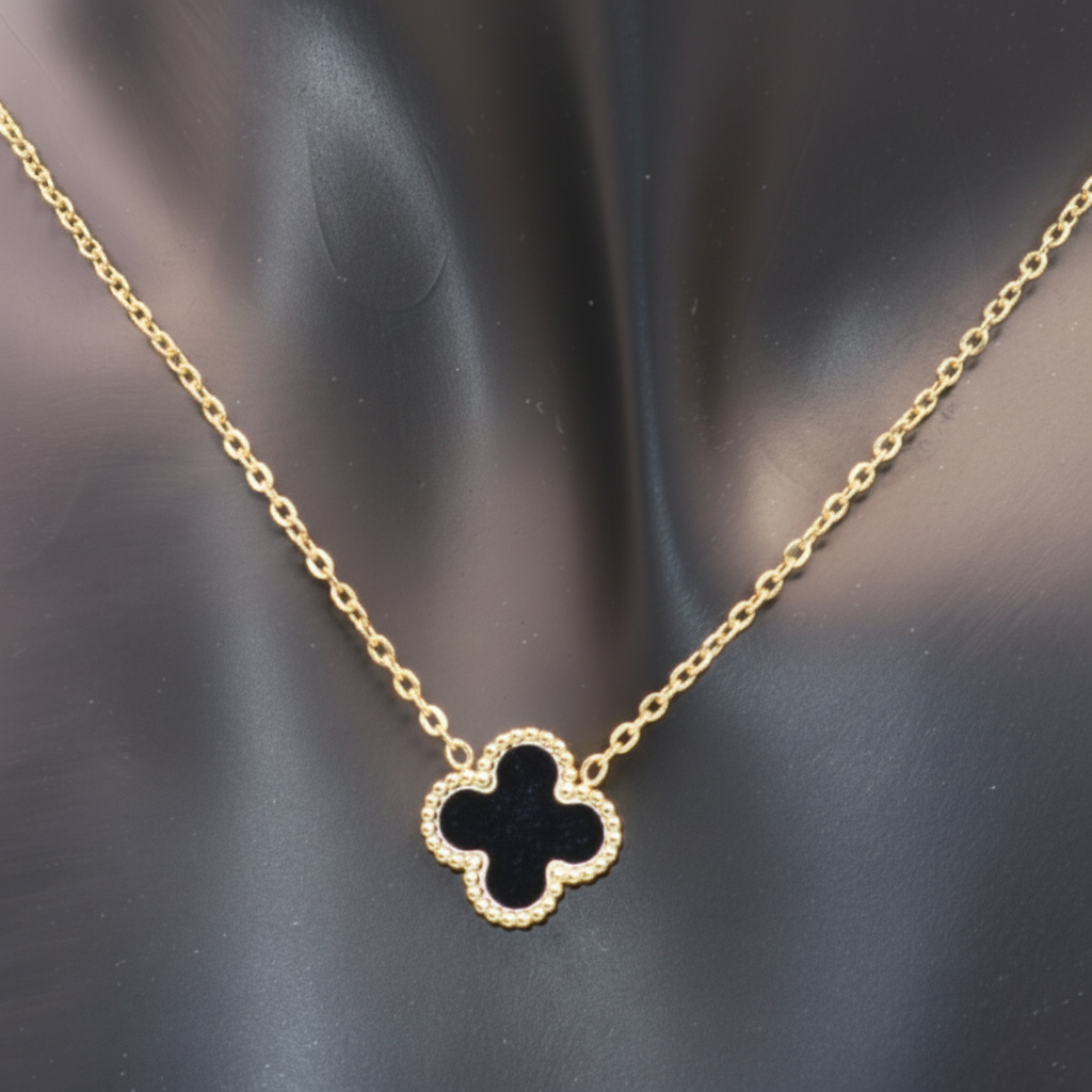Gold necklace with a Black clover-shaped pendant 