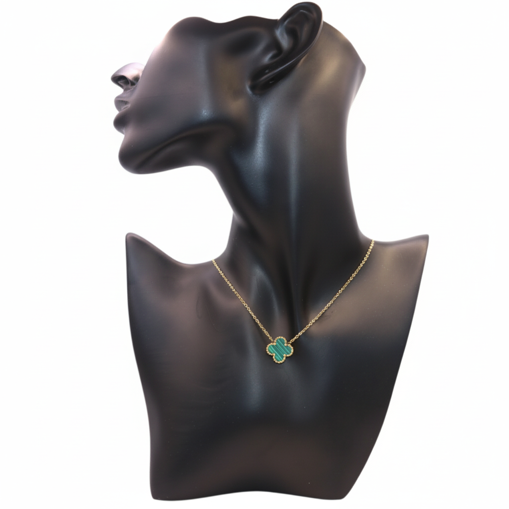 gold necklace featuring a  Green clover-shaped pendant
