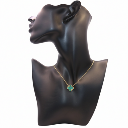 gold necklace featuring a  Green clover-shaped pendant