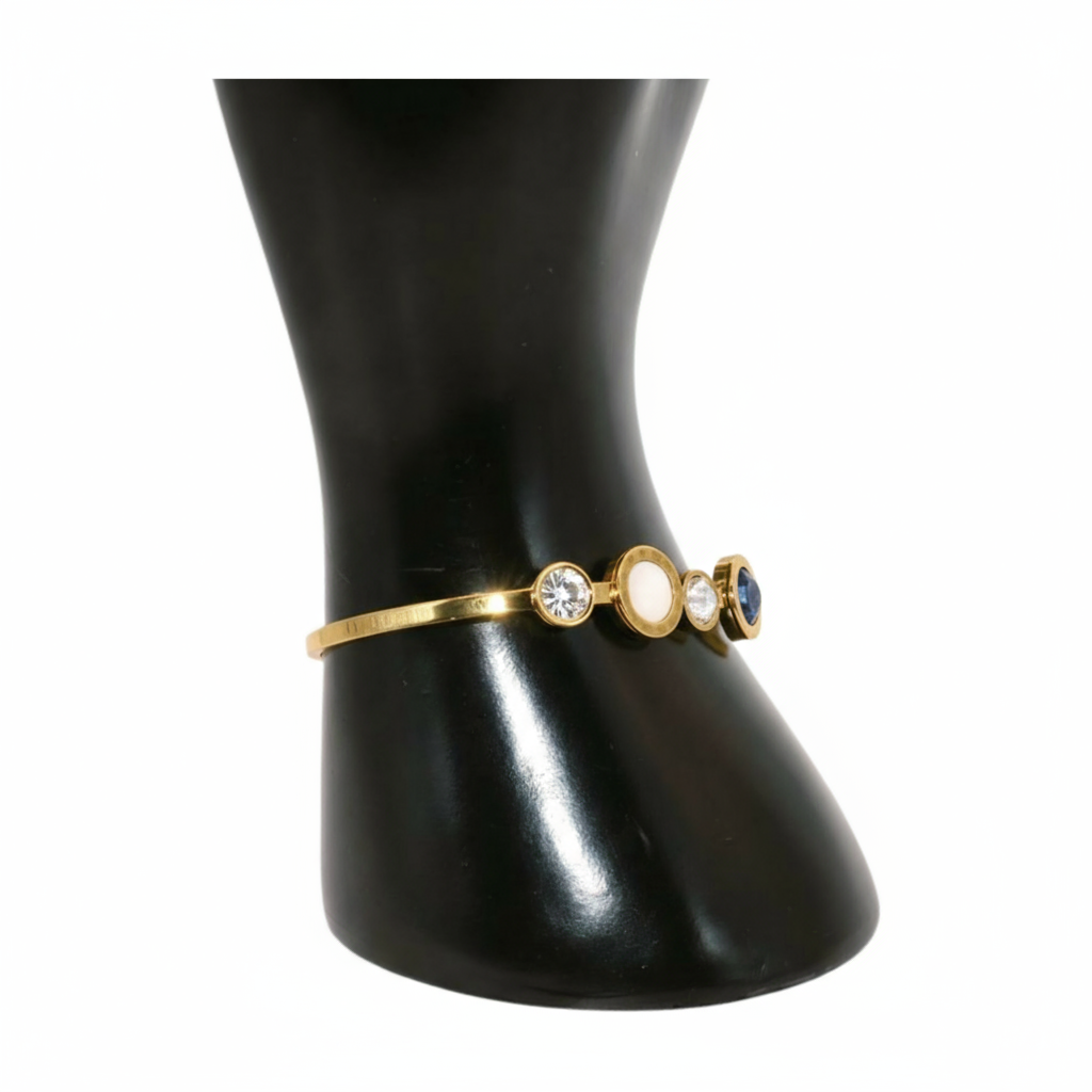 Gold bracelet with three round stones 