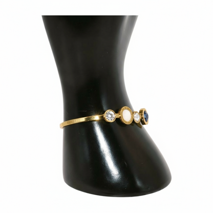 Gold bracelet with three round stones 