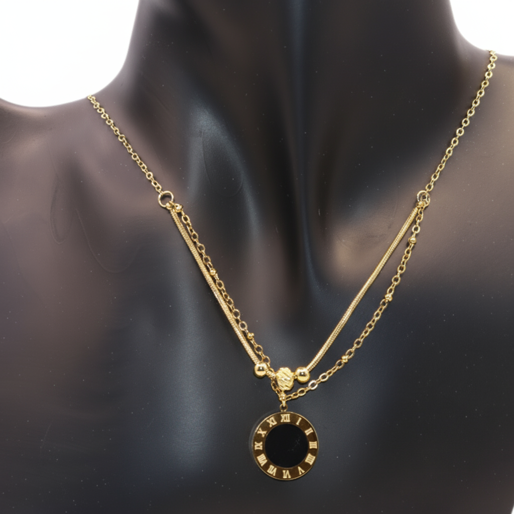 Gold necklace with a black pendant 