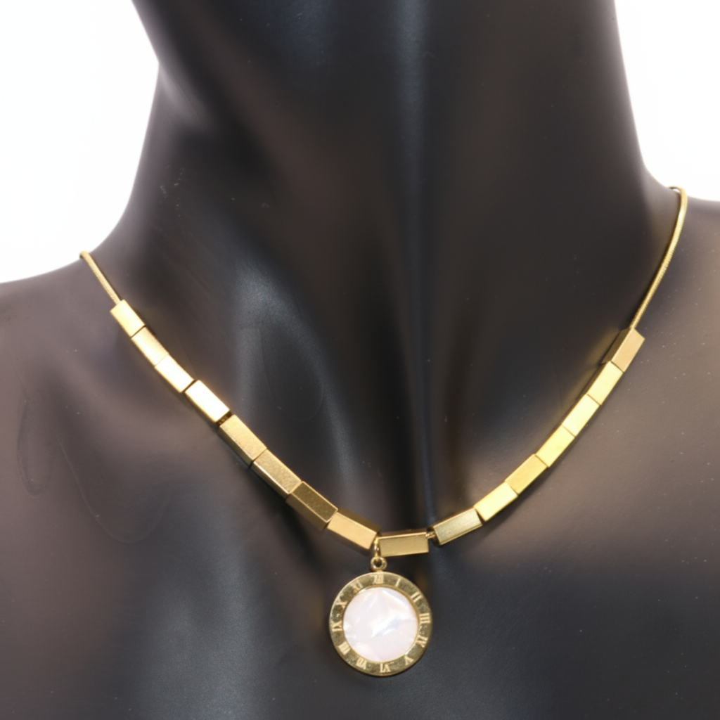Gold necklace with a white pendant 