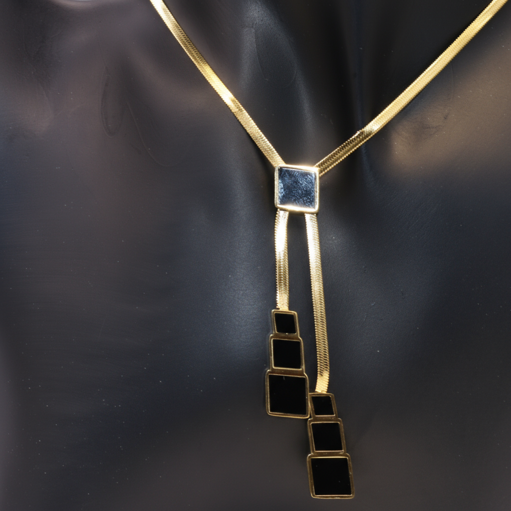 Gold necklace with a unique black pendant 