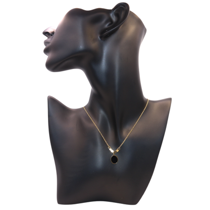 gold necklace with black oval pandant